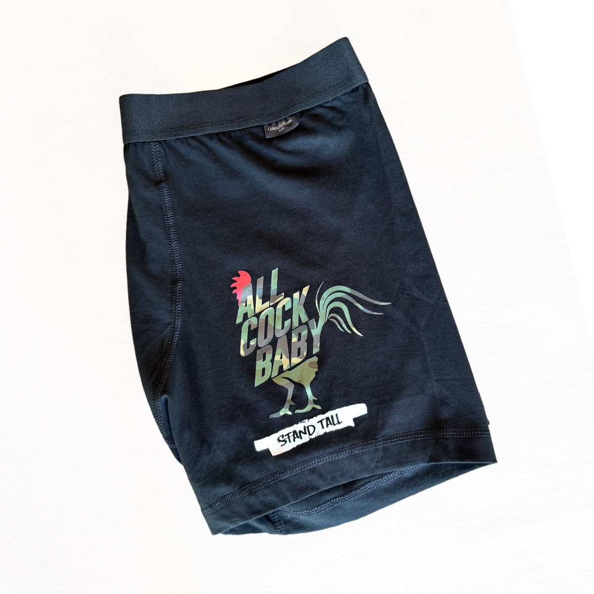Black boxer shorts with colorful graphic and text on a white background